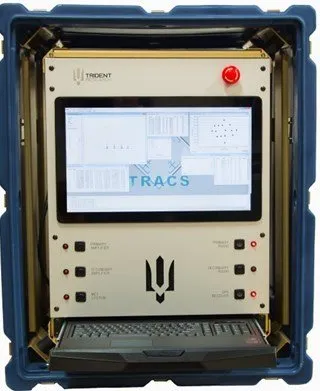 A ruggedized blue-edged case holding a flat-panel display showing the TRACS software, with a keyboard below, a row of buttons and a red button on either side, and a trident emblem at the bottom